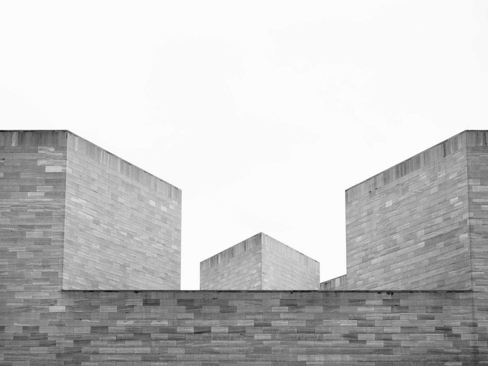 Geometric stone architecture against a pale sky