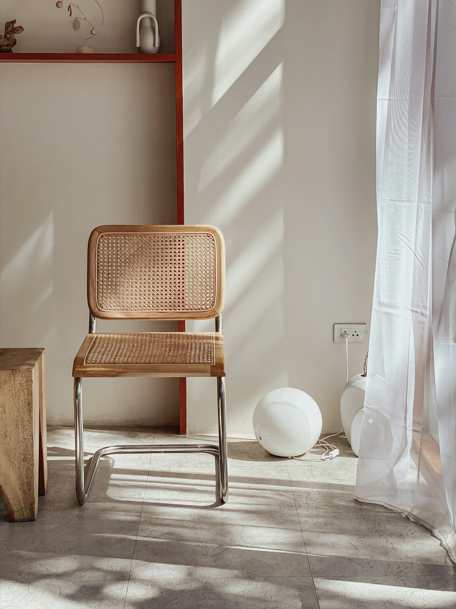 A woven chair in a quiet sunlit interior